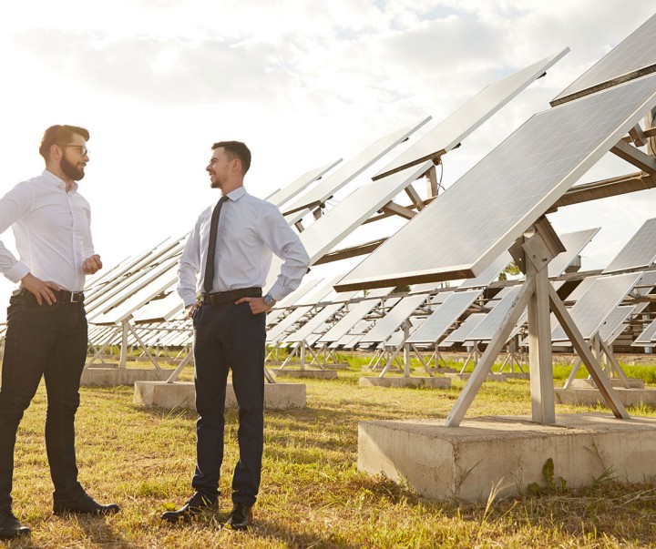 Businessmen talking on solar power plant